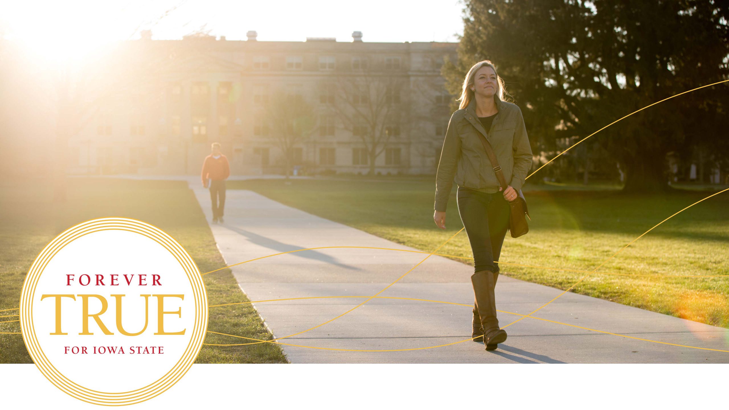 Female student walking on a sidewalk through campus.
