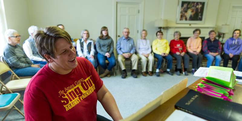 Brandon Brockshus playing piano for a group of older adults