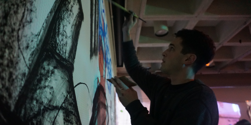 Tom Goetz painting a mural